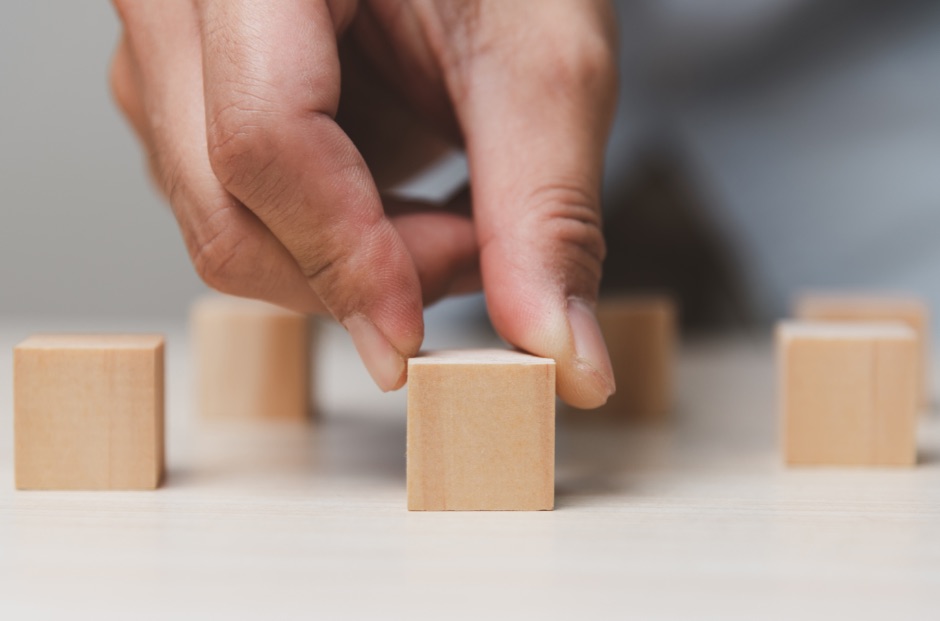 a hand with a building block Business keyman protection