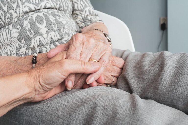 elderly holding hands